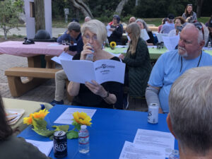 SB Choral members reading from the Beer Chorus Hymnal while at Oak Park celebrating Oak Park 75
